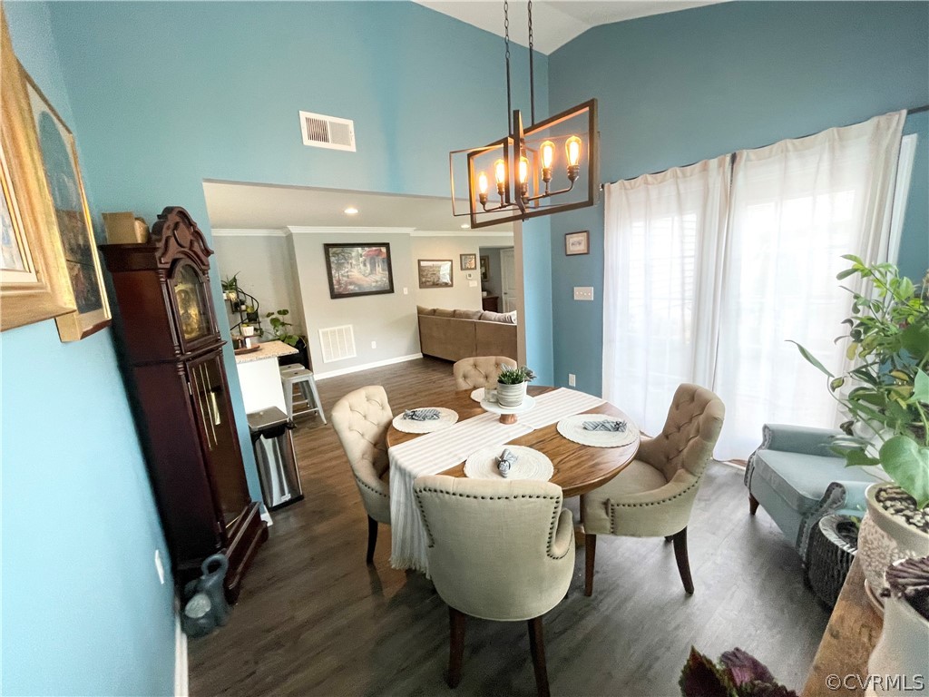 10219 Sandy Ridge Drive Chesterfield, VA 23832 - Photo 15 of 28 a dining room with furniture a chandelier and wooden floor