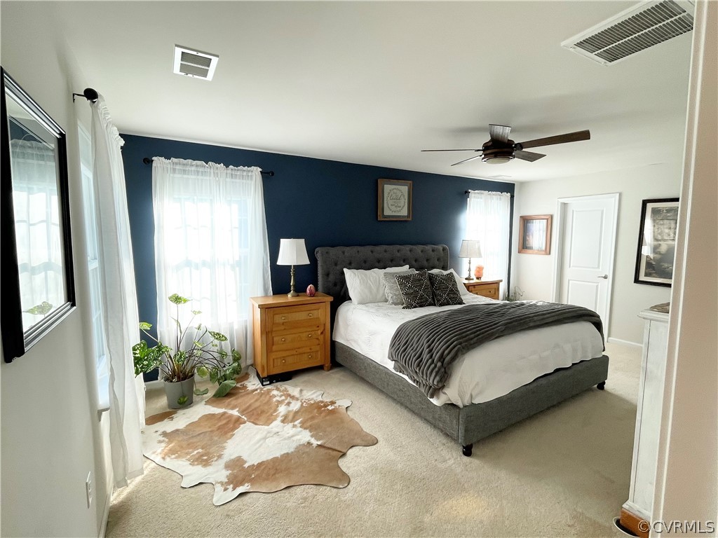 10219 Sandy Ridge Drive Chesterfield, VA 23832 - Photo 19 of 28 a bedroom with a large bed and a potted plant