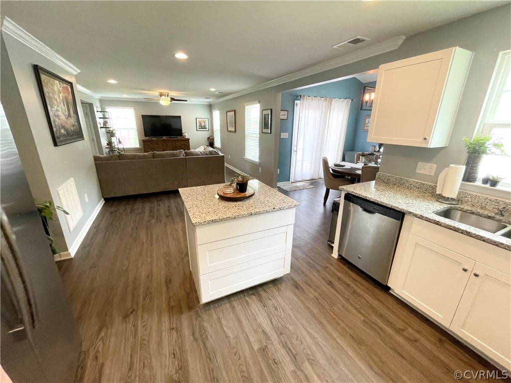 10219 Sandy Ridge Drive Chesterfield, VA 23832 - Photo 6 of 28 a kitchen with stainless steel appliances kitchen island granite countertop a sink stove and refrigerator