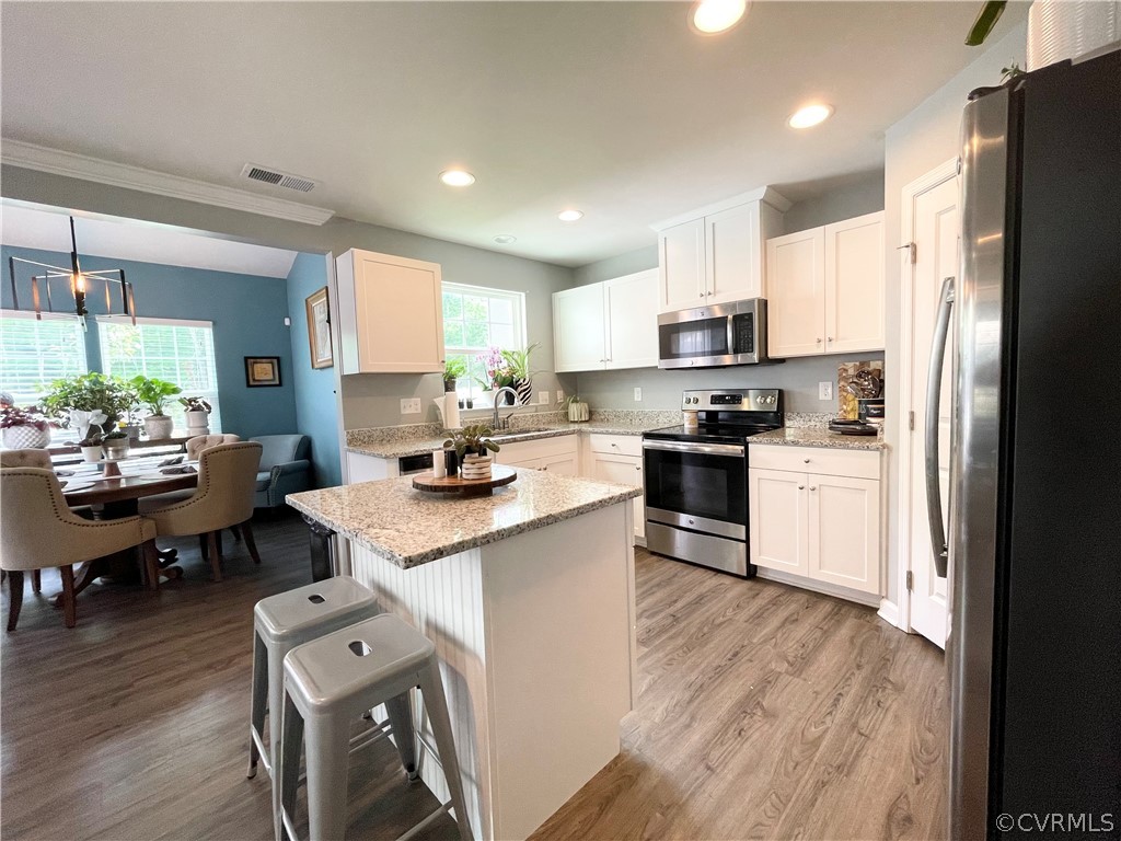 10219 Sandy Ridge Drive Chesterfield, VA 23832 - Photo 9 of 28 a kitchen with white cabinets and stainless steel appliances