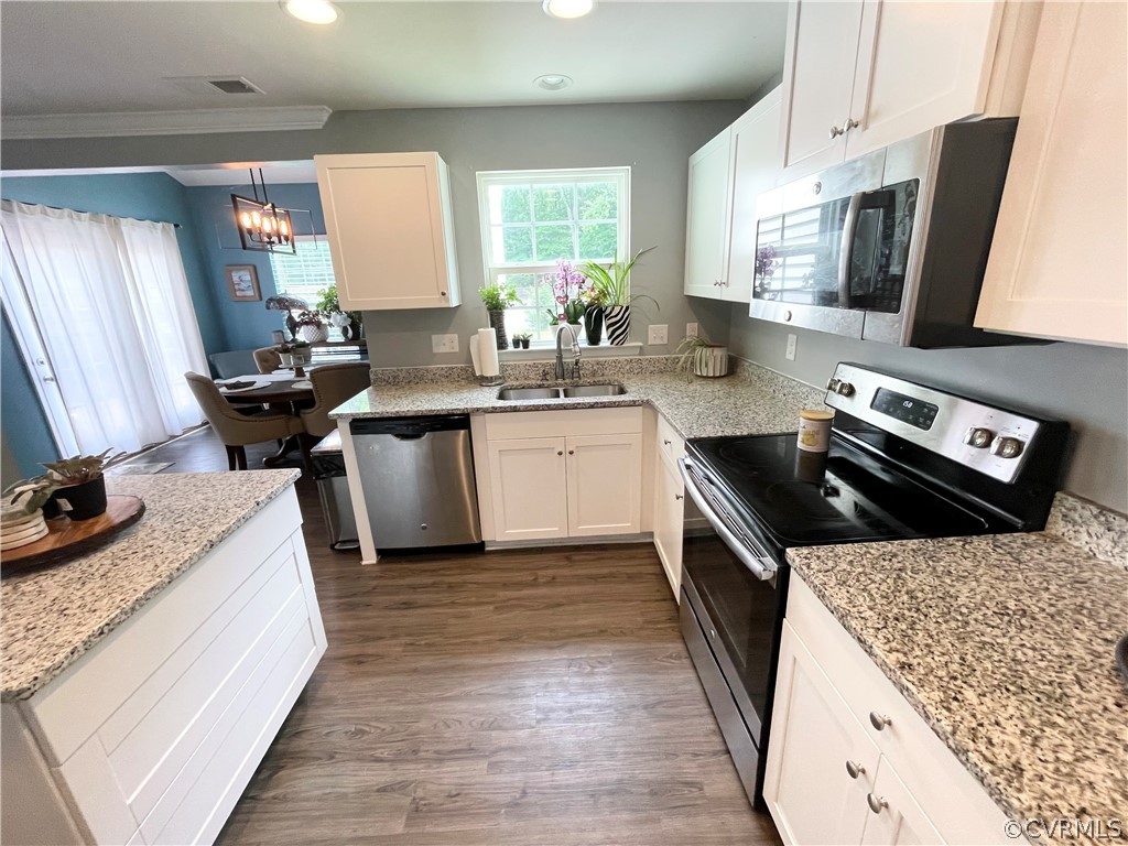 10219 Sandy Ridge Drive Chesterfield, VA 23832 - Photo 10 of 28 a kitchen with stainless steel appliances granite countertop a sink stove and refrigerator