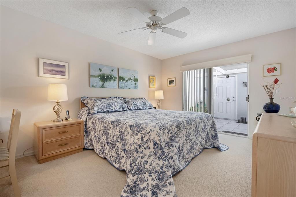 270 Cerromar Way South, Unit 57 Venice, FL 34293 - Photo 17 of 81 a spacious bedroom with a bed and a chandelier