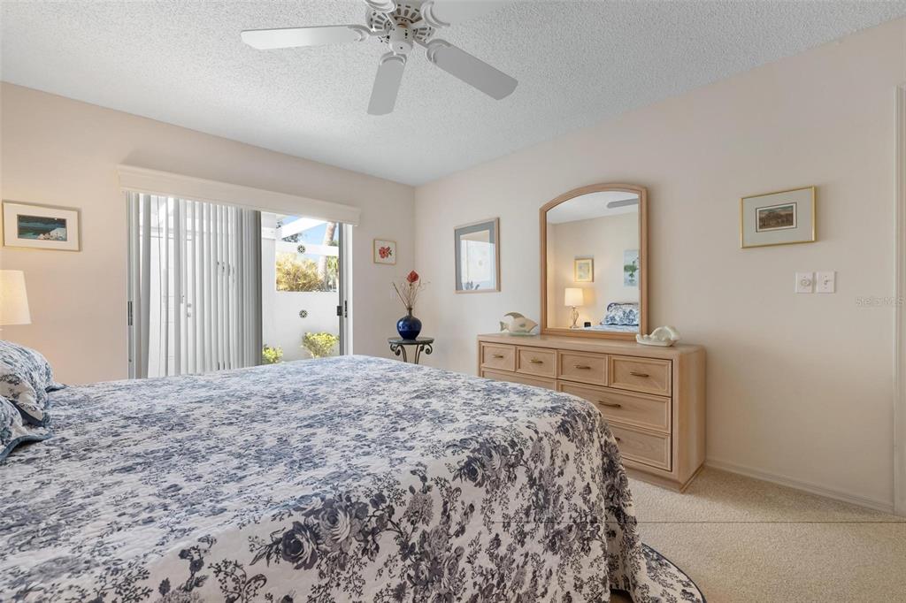 270 Cerromar Way South, Unit 57 Venice, FL 34293 - Photo 18 of 81 a bedroom with a bed and a dresser