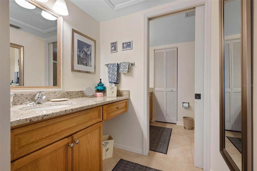 270 Cerromar Way South, Unit 57 Venice, FL 34293 - Photo 20 of 81 a bathroom with a granite countertop sink and a mirror