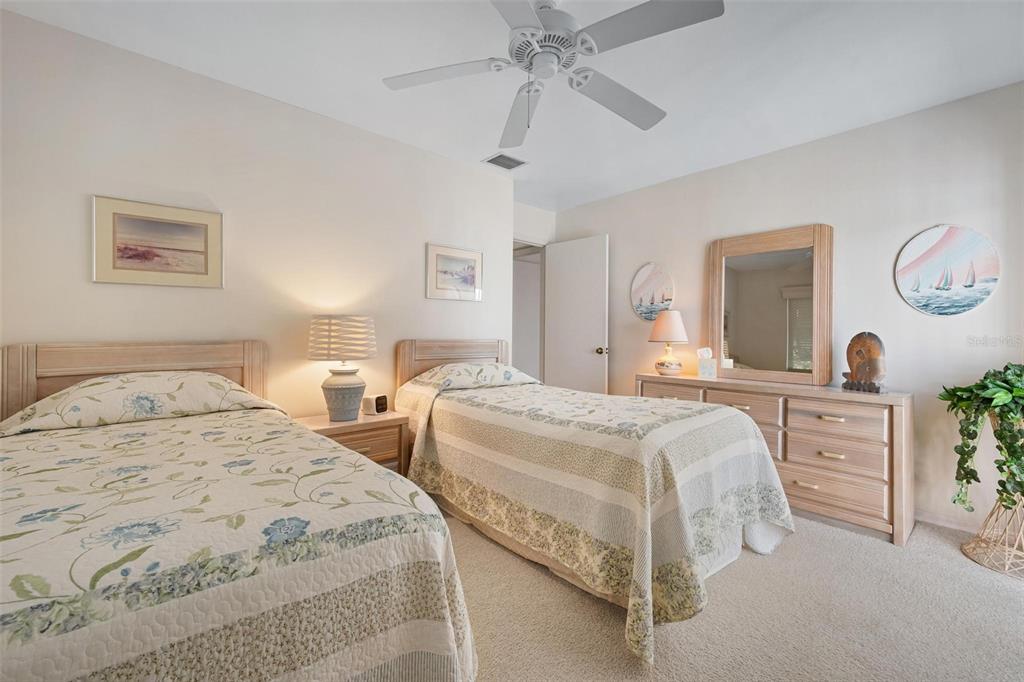 270 Cerromar Way South, Unit 57 Venice, FL 34293 - Photo 24 of 81 a bedroom with two beds and a dresser