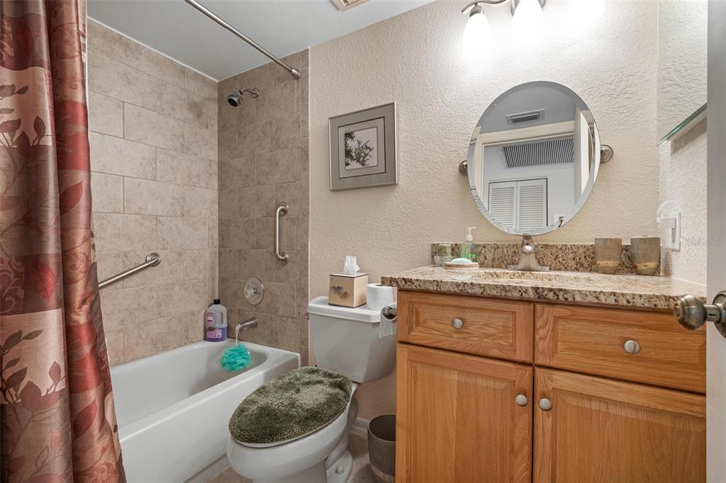 270 Cerromar Way South, Unit 57 Venice, FL 34293 - Photo 25 of 81 a bathroom with a granite countertop toilet a sink and a bathtub