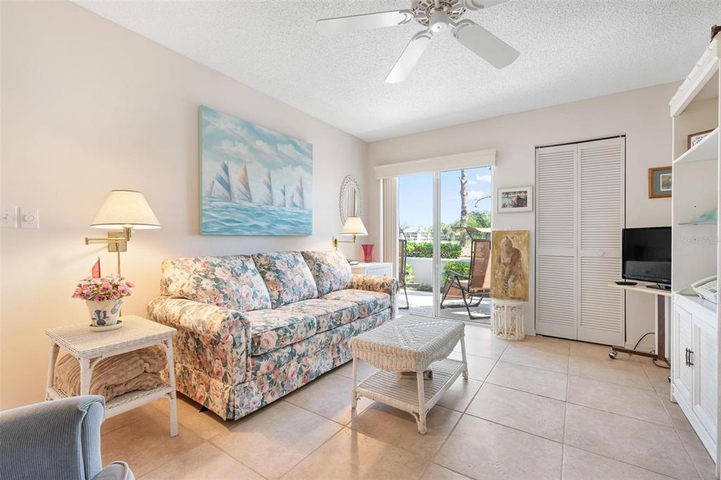 270 Cerromar Way South, Unit 57 Venice, FL 34293 - Photo 27 of 81 a living room with furniture and a flat screen tv
