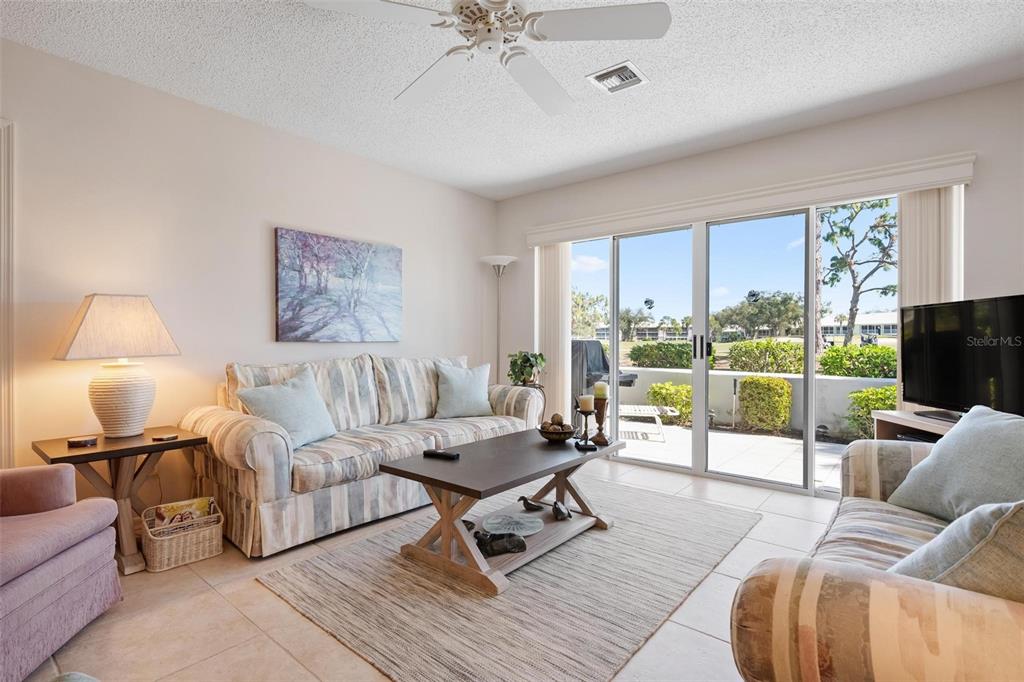 270 Cerromar Way South, Unit 57 Venice, FL 34293 - Photo 6 of 81 a living room with furniture and a flat screen tv