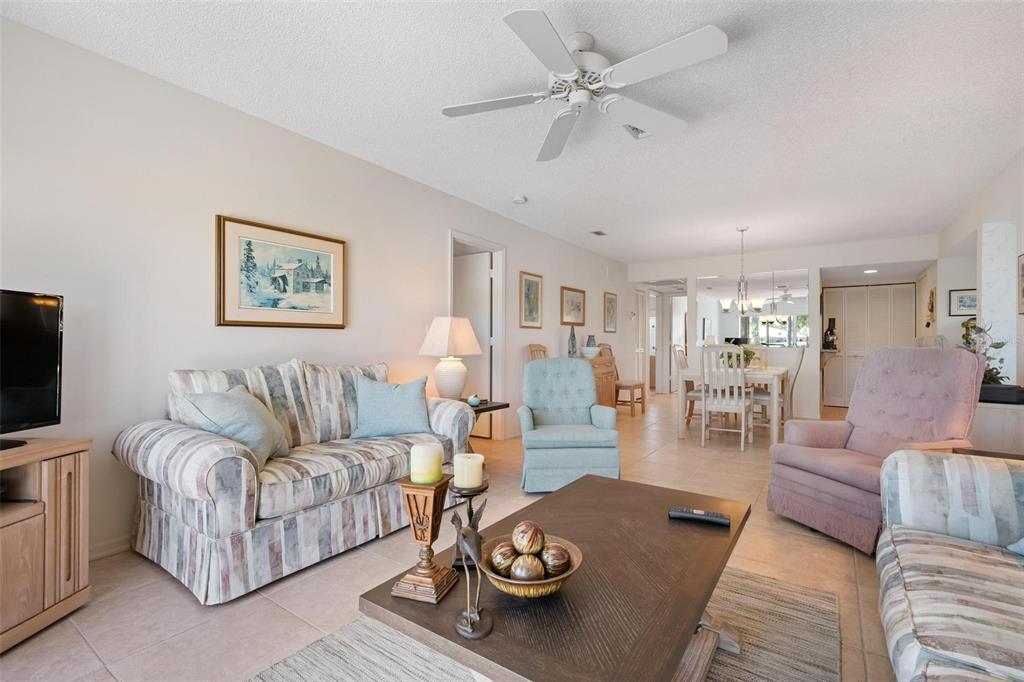 270 Cerromar Way South, Unit 57 Venice, FL 34293 - Photo 7 of 81 a living room with furniture a rug and a flat screen tv