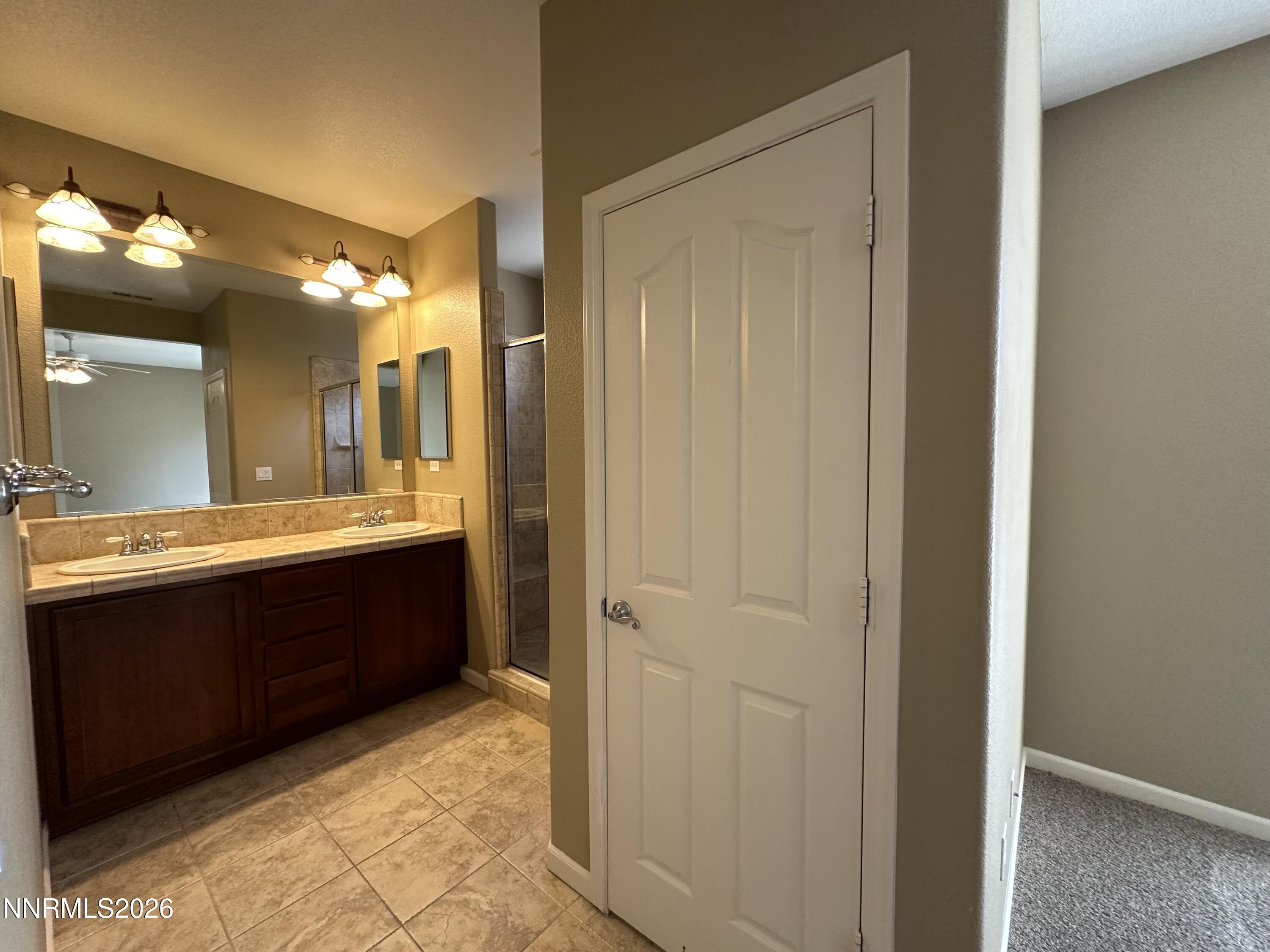13755 Seabiscuit Drive Reno, NV 89521 - Photo 11 of 19 a bathroom with a bathtub and a sink