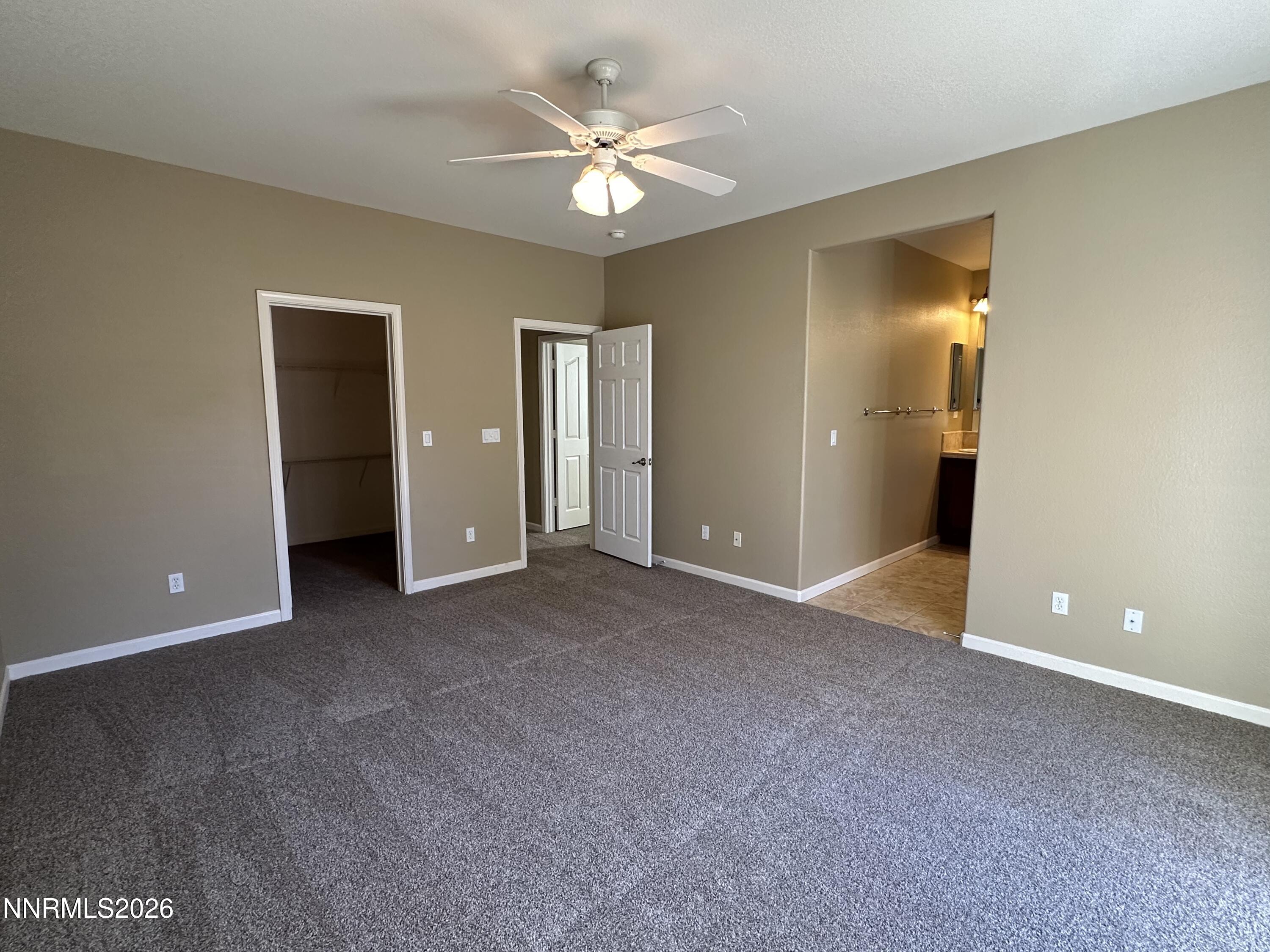 13755 Seabiscuit Drive Reno, NV 89521 - Photo 14 of 19 a view of a room with a ceiling fan and a bathroom