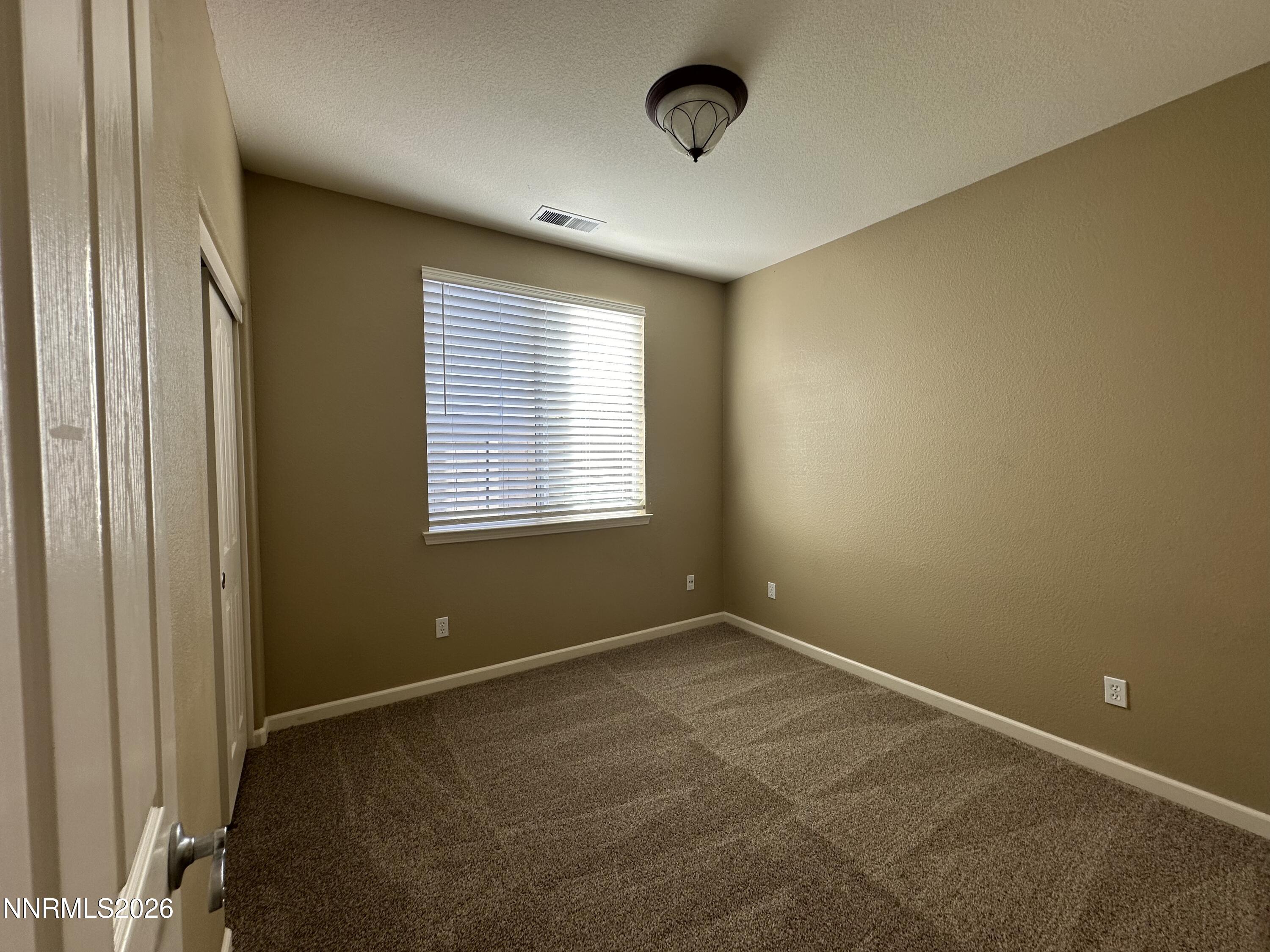 13755 Seabiscuit Drive Reno, NV 89521 - Photo 16 of 19 an empty room with a empty space and windows