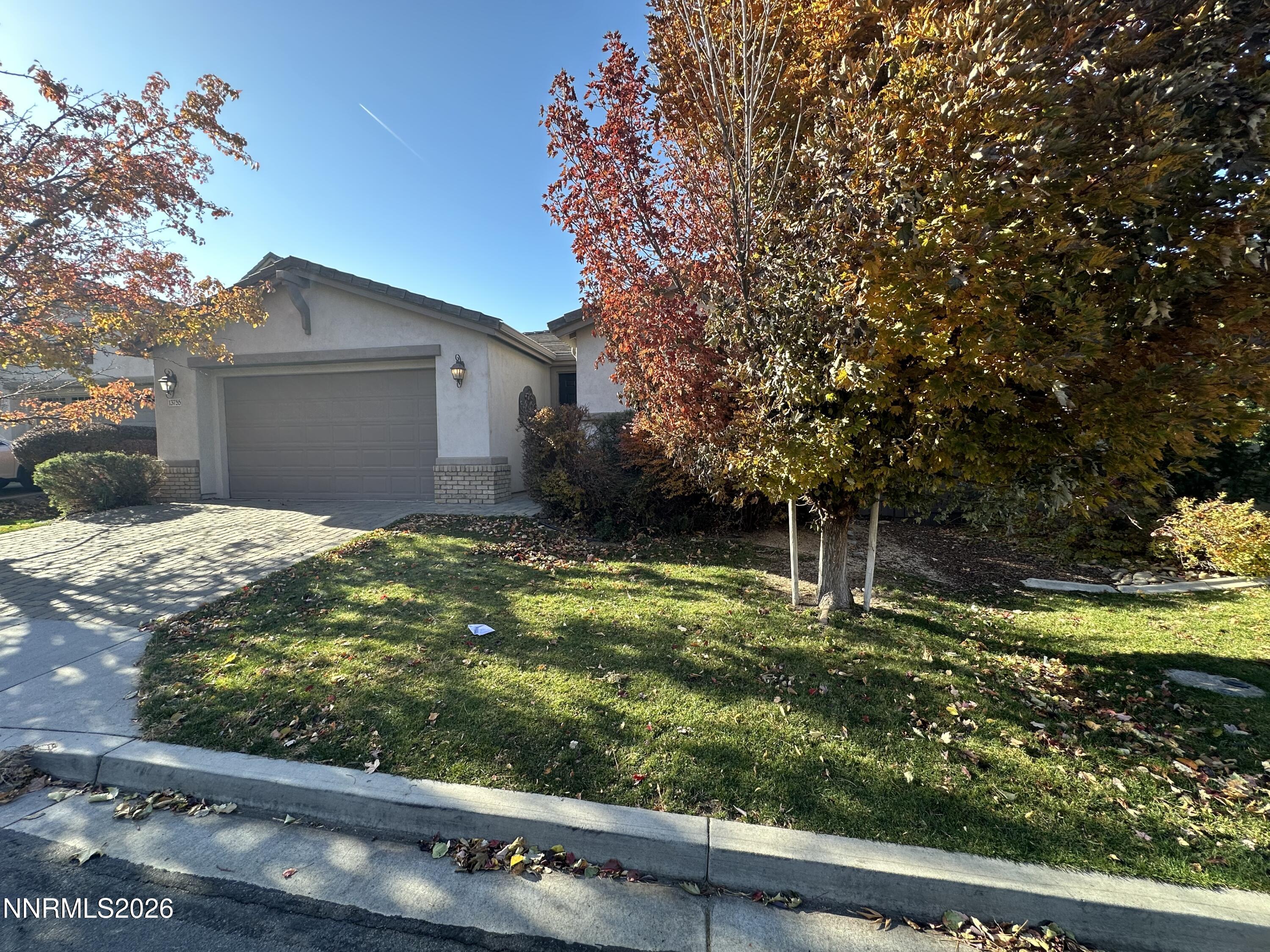 13755 Seabiscuit Drive Reno, NV 89521 - Photo 2 of 19 a backyard of a house with lots of green space and plants