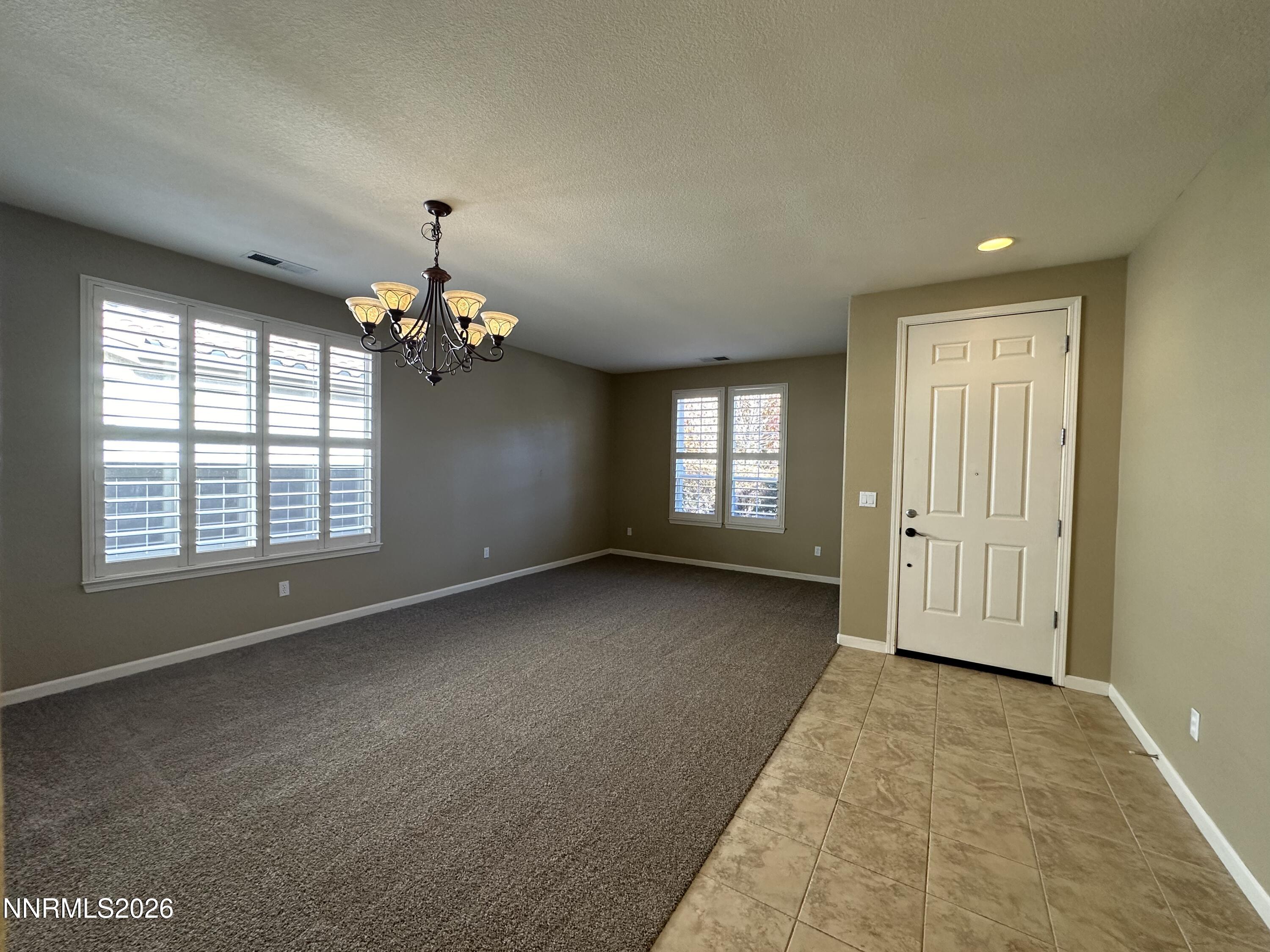 13755 Seabiscuit Drive Reno, NV 89521 - Photo 4 of 19 a view of an empty room with a window