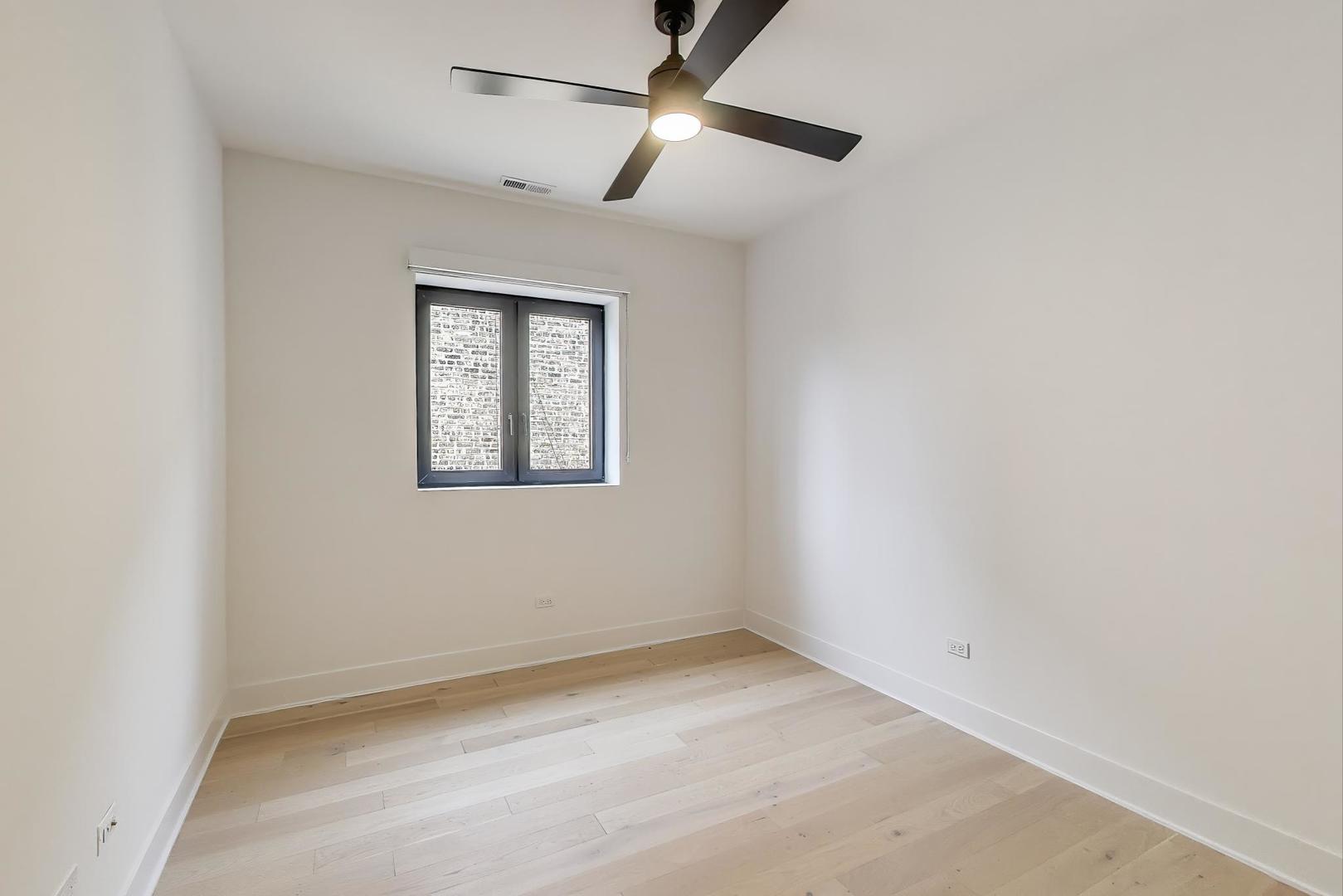1619 West Lawrence Avenue, Unit 2 Chicago, IL 60640 - Photo 12 of 19 an empty room with a window and a fan