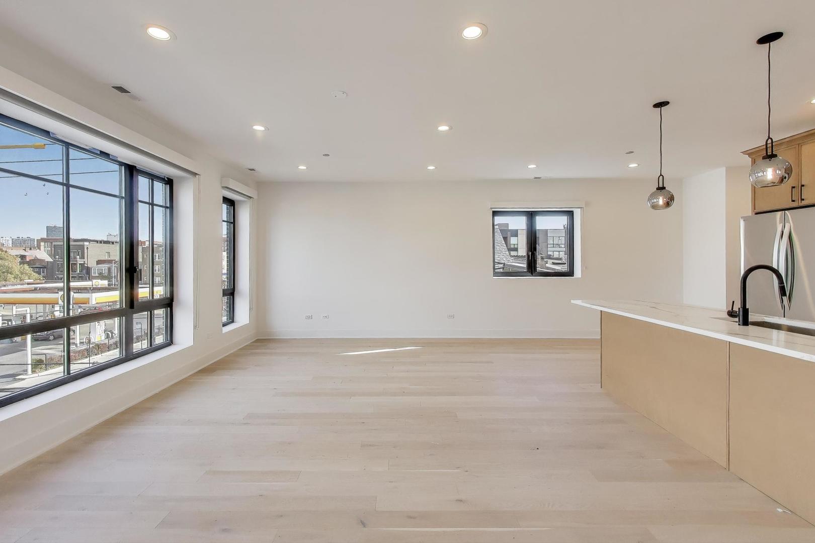 1619 West Lawrence Avenue, Unit 2 Chicago, IL 60640 - Photo 4 of 19 a view of an empty room with a window