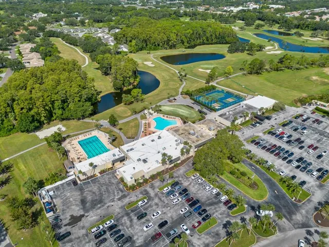 an aerial view of a house with a big yard and garden