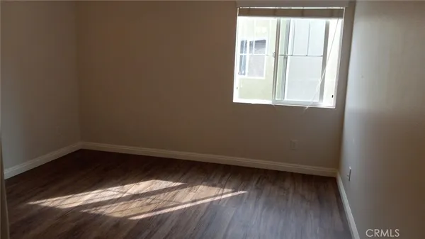 a view of room with window and hardwood floor