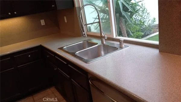 a kitchen with a sink and a large window