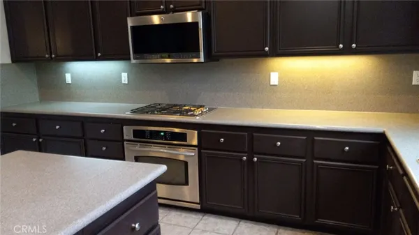 a kitchen with a sink a stove and cabinets