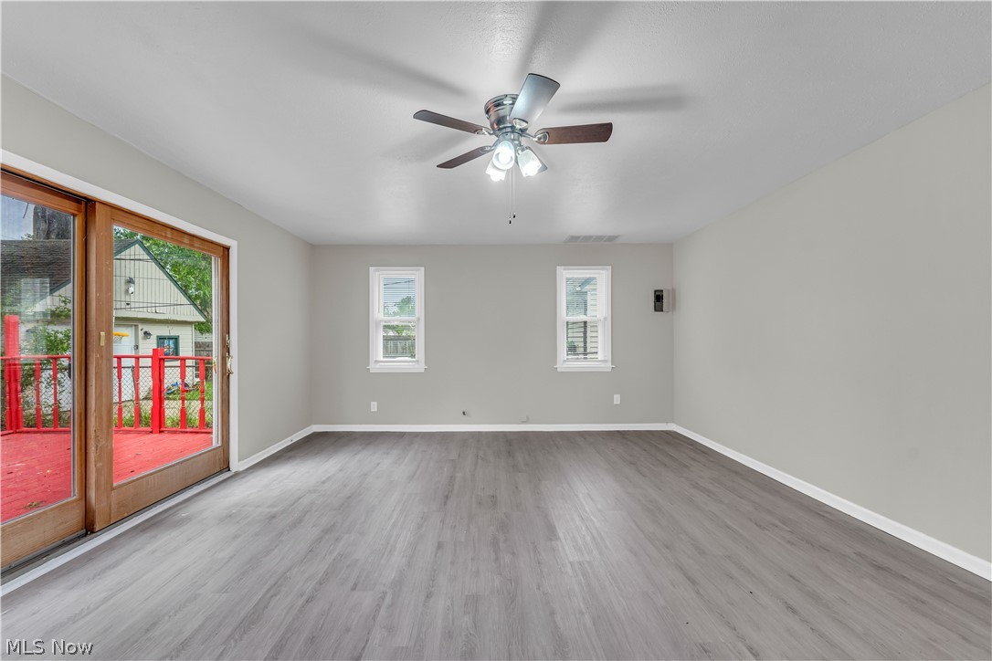 18517 Homeway Road Cleveland, OH 44135 - Photo 8 of 29 Spacious room featuring wood-finish flooring, light gray walls, and a ceiling fan with integrated lighting