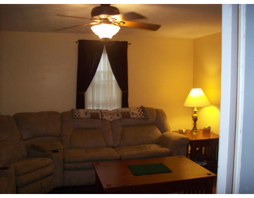 8 Pine Street, Unit 1 Peabody, MA 01960 - Photo 4 of 7 a living room with couches and chandelier