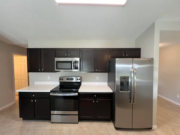 a kitchen with a refrigerator and a stove