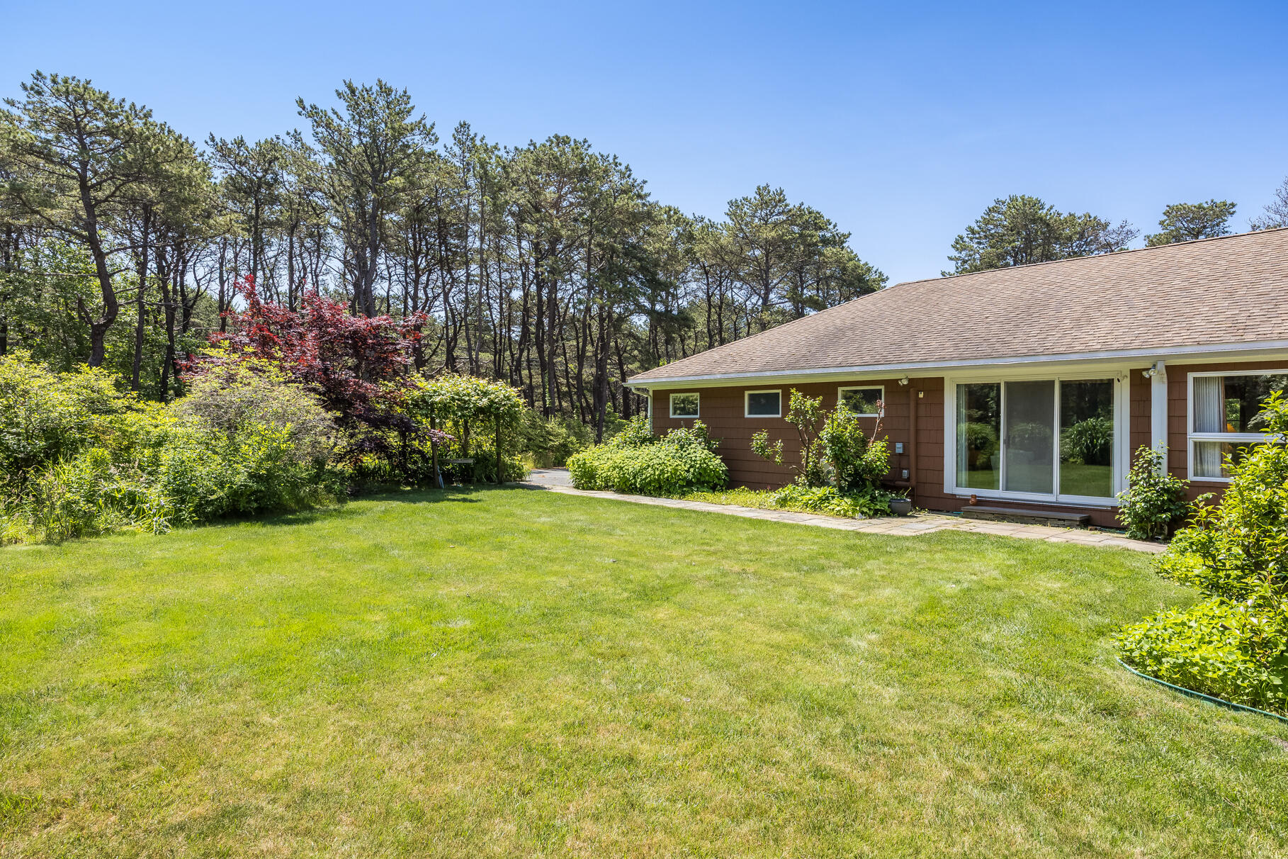 72 South Highland Road Truro, MA 02666 - Photo 36 of 59 a view of a house with a yard and potted plants