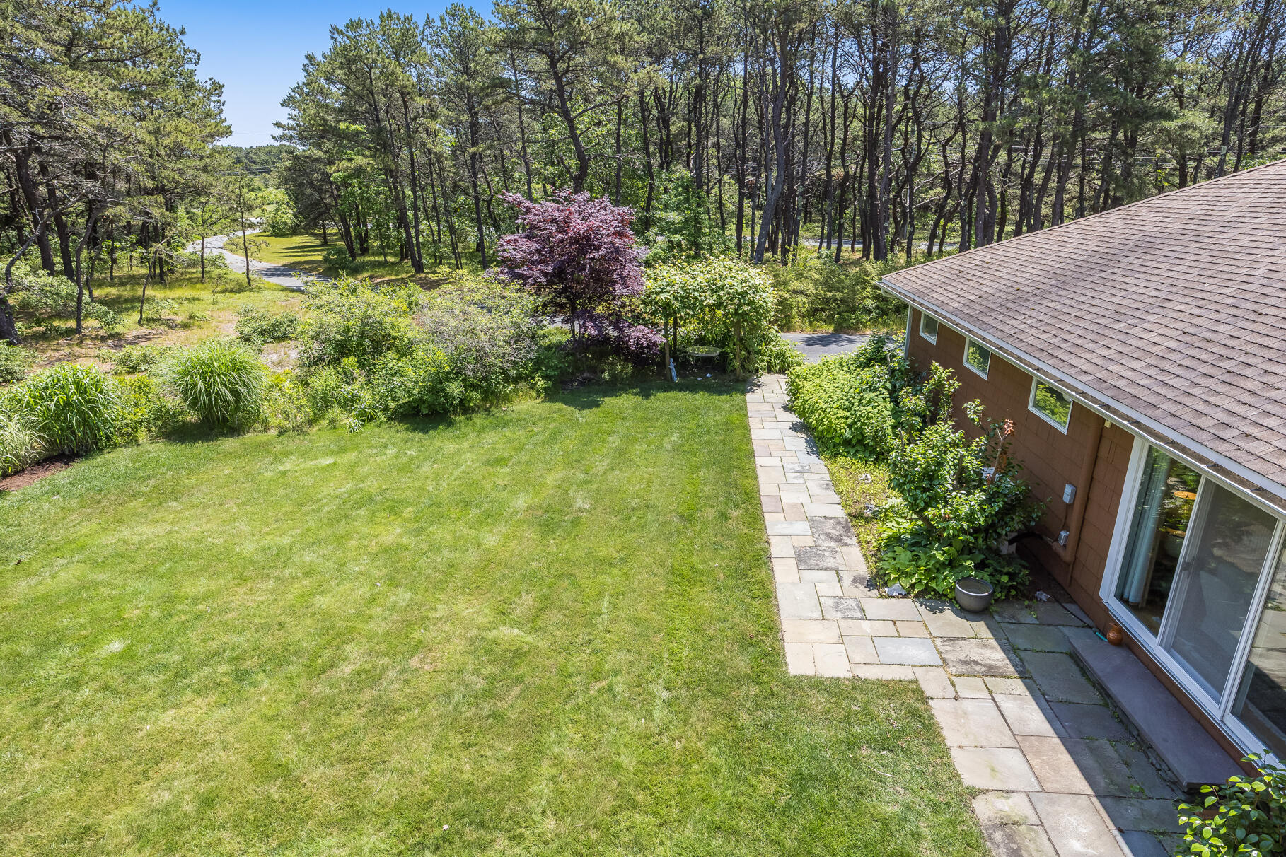 72 South Highland Road Truro, MA 02666 - Photo 45 of 59 a view of a backyard with potted plants