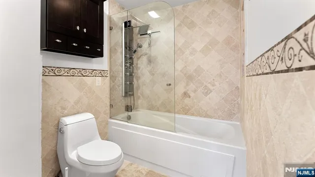 a bathroom with a toilet a sink and bathtub