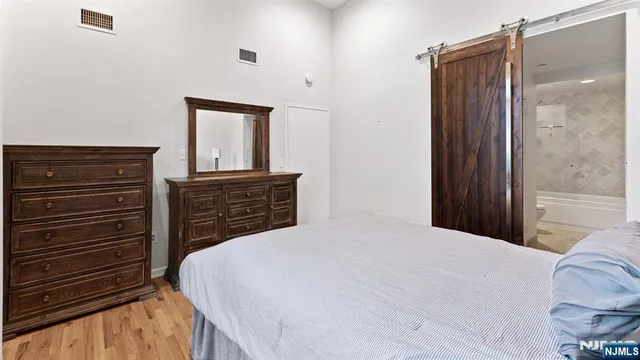 a bedroom with a bed and a dresser