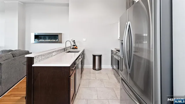 a kitchen with stainless steel appliances a refrigerator and a stove