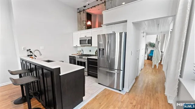 a kitchen with cabinets and stainless steel appliances