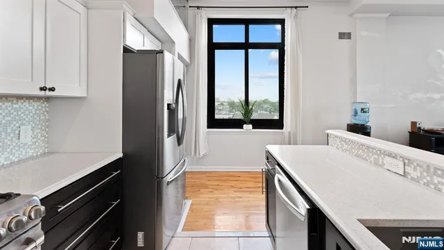 a kitchen with a refrigerator and a sink