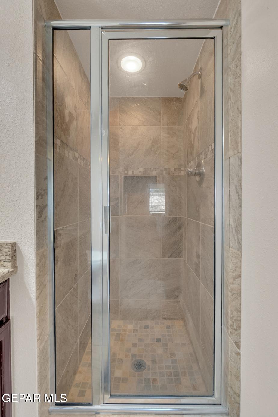 11349 West Ranch Court El Paso, TX 79934 - Photo 29 of 61 a bathroom with a glass shower door