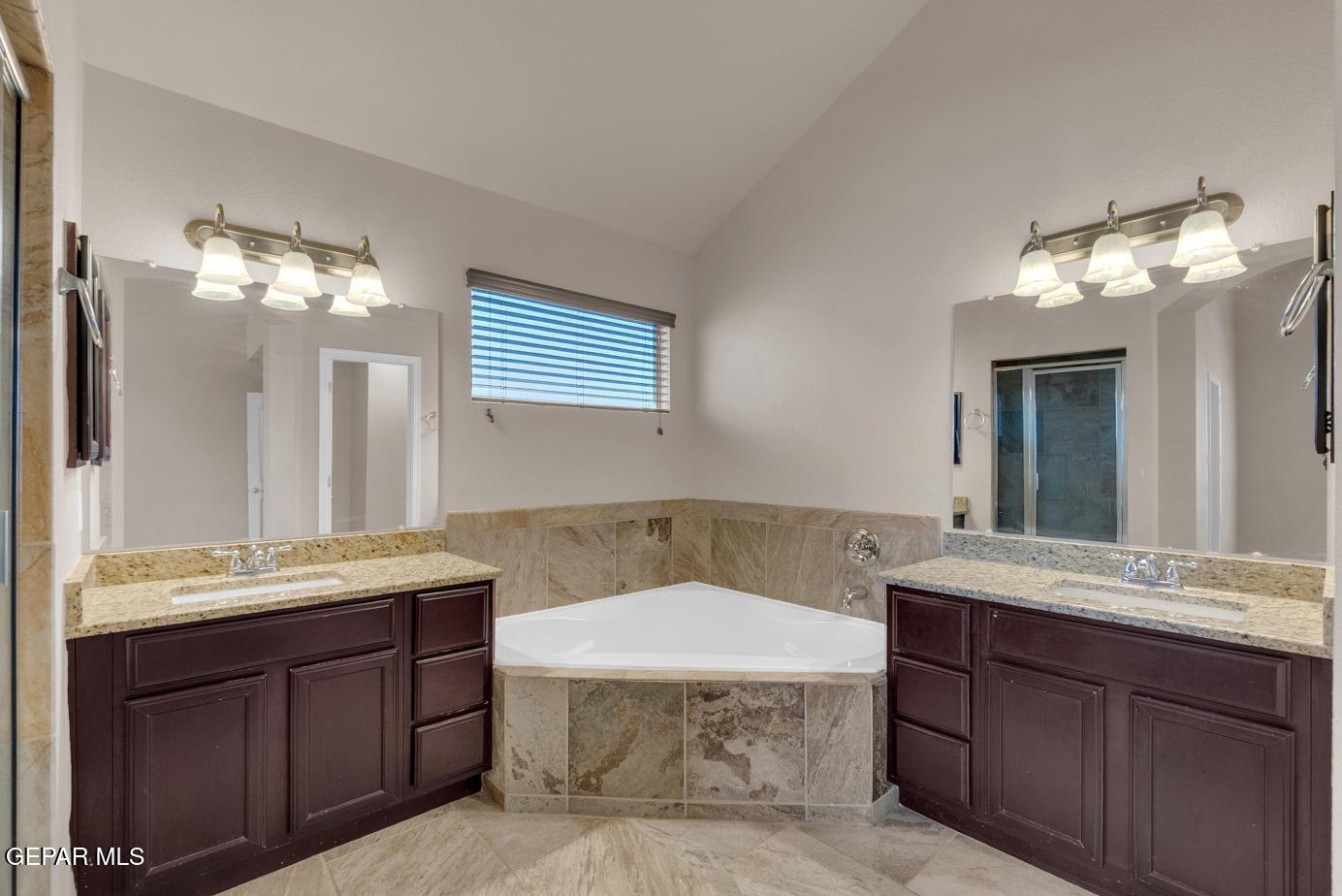 11349 West Ranch Court El Paso, TX 79934 - Photo 46 of 61 a bathroom with a sink a light fixture and a mirror