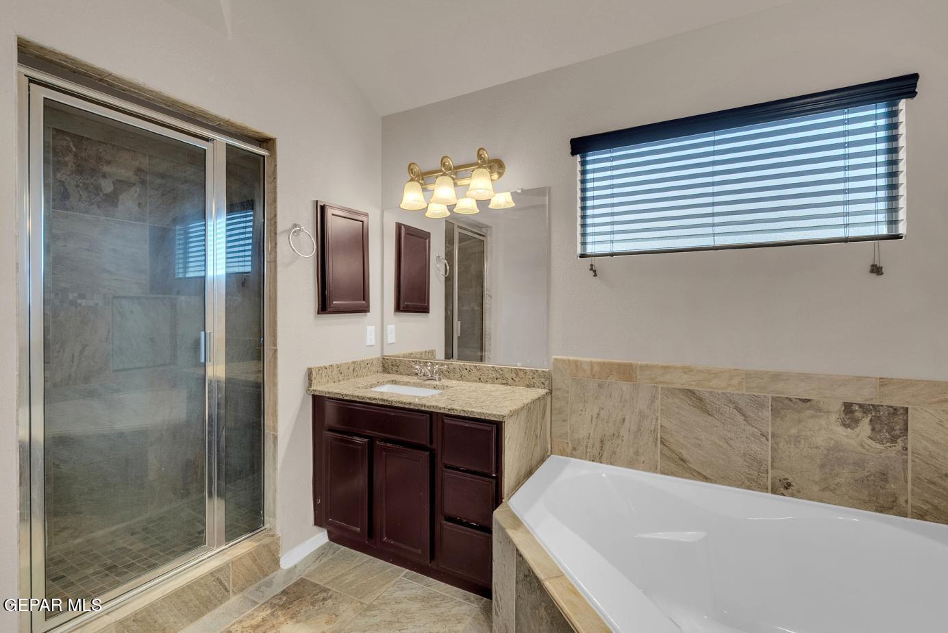 11349 West Ranch Court El Paso, TX 79934 - Photo 48 of 61 a bathroom with a granite countertop sink and a mirror