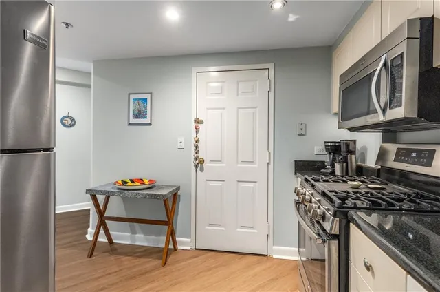 a kitchen with stainless steel appliances granite countertop a stove and a refrigerator