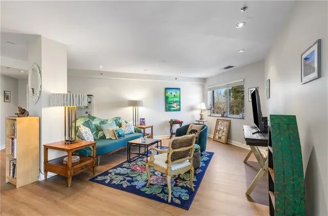 a living room with furniture rug and a large window