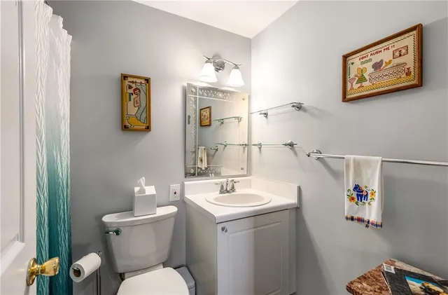 a bathroom with a toilet sink and mirror