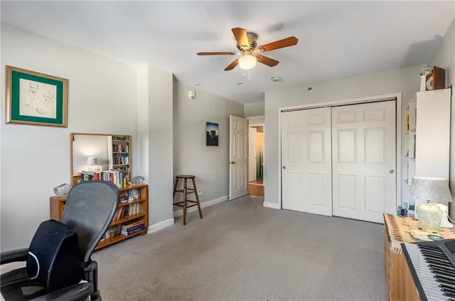 a view of a livingroom with workspace and a window