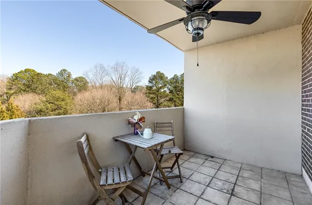 a view of a dining table and chairs in a balcony