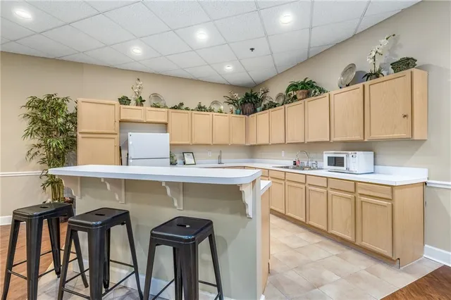 a kitchen with cabinets and chairs