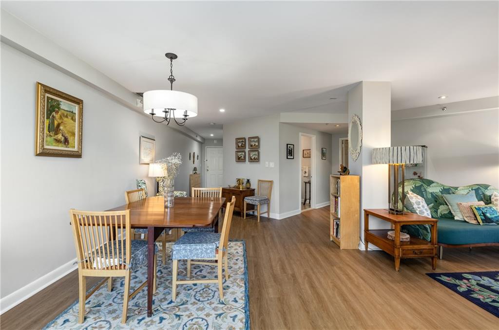 1501 Clairmont Road, Unit 535 Decatur, GA 30033 - Photo 6 of 34 a dining room with wooden floor a chandelier a wooden table and chairs