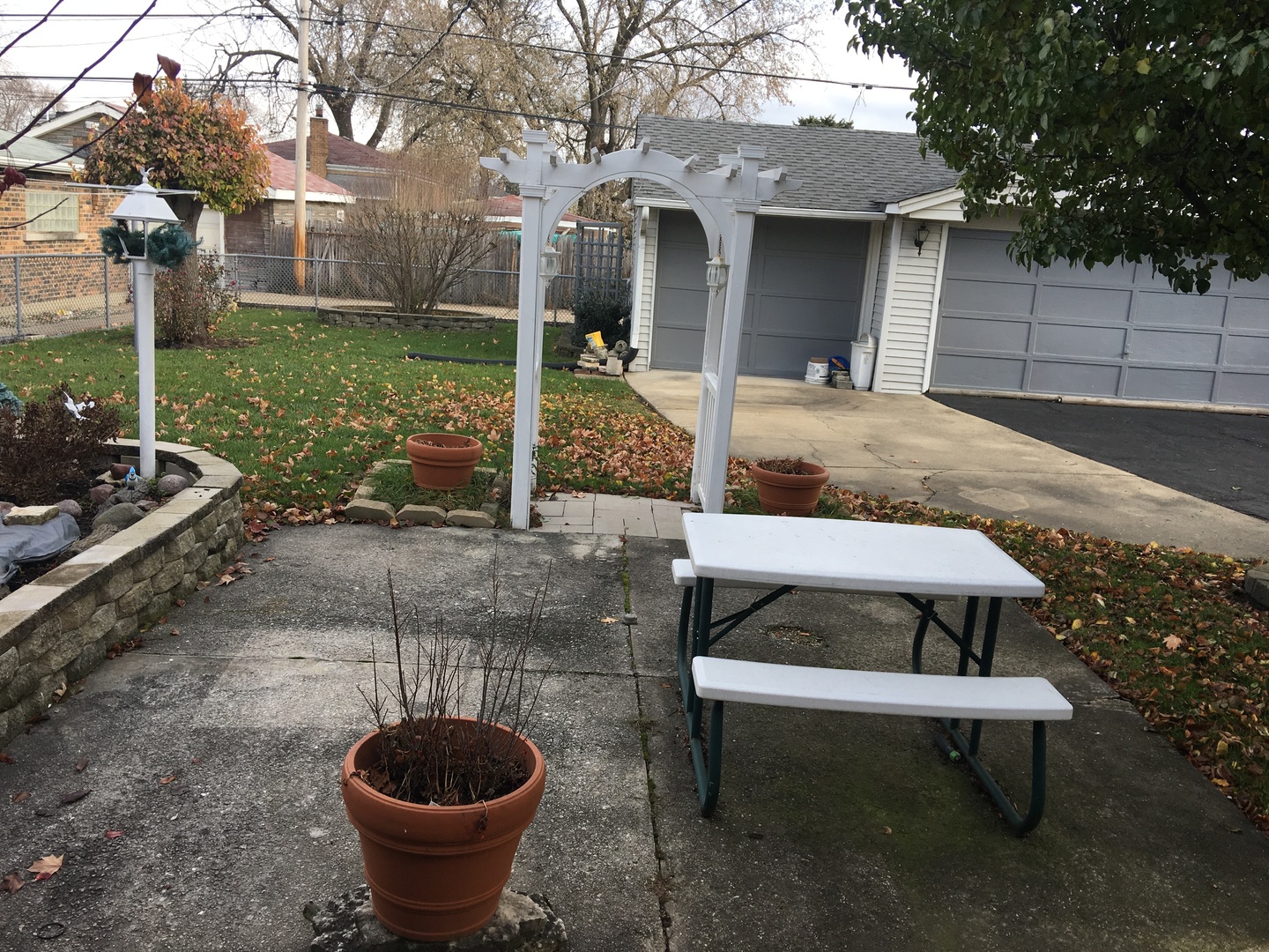 4919 Long Avenue Chicago, IL 60638 - Photo 5 of 29 a view of a backyard with table and chairs potted plants and large tree