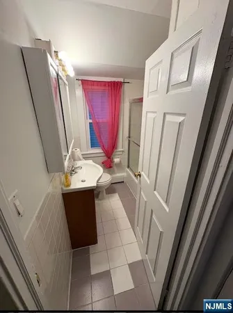a bathroom with a sink a mirror and shower