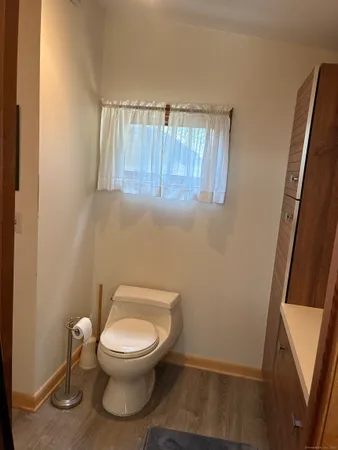 a white toilet sitting next to a small sink