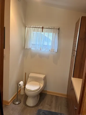 a white toilet sitting next to a small sink