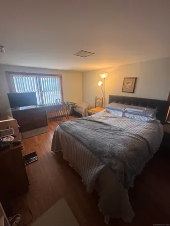 a bedroom with a bed and window