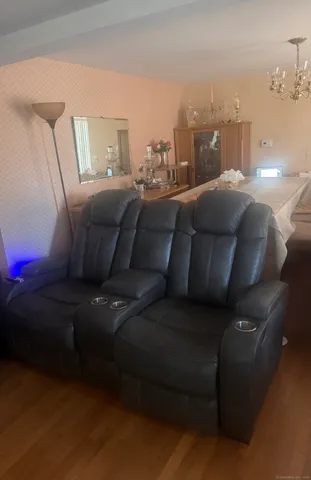 a living room with furniture and a mirror